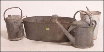 A collection of vintage 20th century galvanized items to include two watering cans,