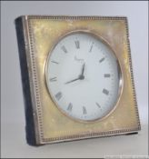A 20th century silver hallmarked desk clock having a roman numeral chapter ring and Asprey to the