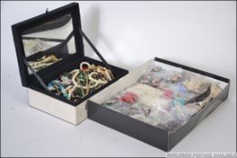 A collection of costume jewellery items within a jewellery box to include necklaces,