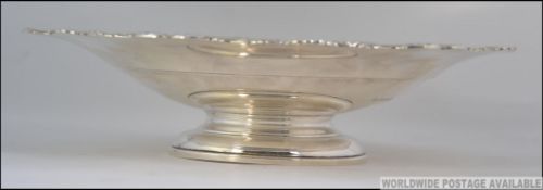 A silver hallmarked footed bowl tazza having scalloped edges.