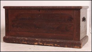 A Victorian scrumble finished pine blanket box chest with hinged top and plinth base.