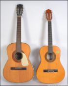A Spanish style six string acoustic guitar made in West Germany by Hoyner along with a three
