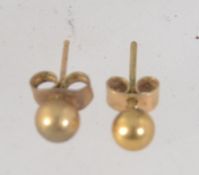 A pair of 9ct gold ball stud earrings with post backs. Marked 375 tests 9ct.