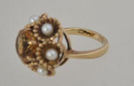 A 9ct gold Art Deco dress ring with central round cut citrine surrounded by scalloped set pearls in
