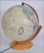 A good quality desk top globe raised on a wooden swivel mount and plinth.