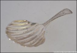 A silver hallmarked 18th century caddy spoon with shell bowl possibly by James Beattie 1790 or John