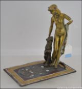 A 20th century Art Deco Austrian cold painted bronze figure of a female figure with a seated puma
