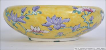 A 19th century Chinese famille Juane dish with decorative birds of paradise design on yellow ground