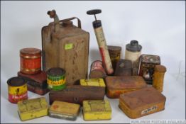 A collection of assorted vintage advertising tins, oil cans, toffee tins,
