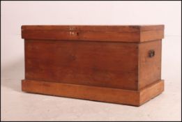 A Victorian pine blanket box chest having plinth base with carry handles to sides, hinged top above.