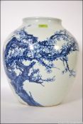 A large 20th century Japanese blue and white floor pot heavily decorated with with a continuous