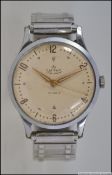 A vintage mid century gentlemans Smiths De Lux 17 Jewel wristwatch on expanding steel bracelet.