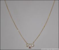 A 9ct gold, ruby and diamond pendant and necklace,