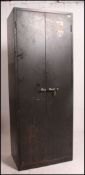 A large 1950's green Industrial / military metal stationary locker cupboard having twin doors with