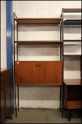 A 1970's Ladderax / Avalon system comprising cupboard and shelves with ebonised metal slatting and