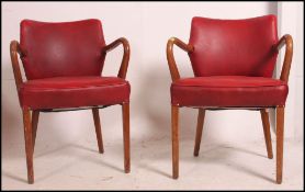 2 1960's Ben Chair type armchairs having show wood angular frames and arm rests upholstered in the