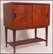 A good 1960's Danish influence teak small side cabinet with tambour sliding door,