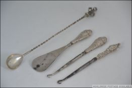 A silver large twizzle spoon with crown top,