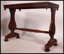 A 19th century Regency mahogany writing table raised on lyre shaped supports with pad feet united