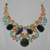 A large ladies contemporary silver and multi gem stone necklace choker.