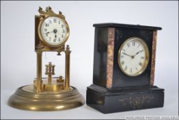 An early 20th century black and rouge marble mantle clock along with brass torsion clock,
