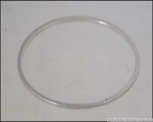 A Danish Georg Jensen silver bangle of silver form purchased originally by the vendor in Denmark in