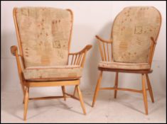 An Ercol beech and elm wood windsor armchair of hoop back raised on saddle seat with crinoline