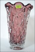 A heavy Studio Glass vase of tapering form with an applied lattice work finish.