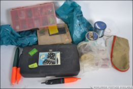 A collection of vintage fishing accessories to include fly's, floats, hooks,