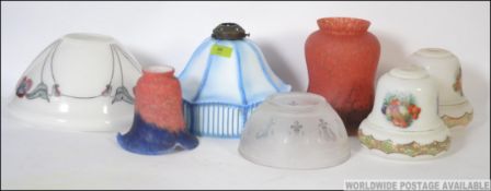 A collection of seven vintage glass light shades of varying designs and colours please see images.