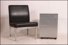 A vintage industrial style three drawer short filing cabinet having a polished steel appearance