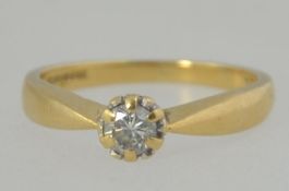 A 9ct gold and diamond single stone ladies ring.