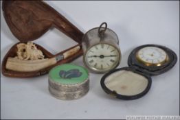 A collection of items to include a Smiths travel clock, a meerschaum pipe with carved ders in case,