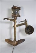A fantastic 20th century upcycled nautical inspired outside lamp being constructed from a brass