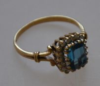A hallmarked 9ct gold ladies dress ring with a large central blue stone and diamond surround 3.