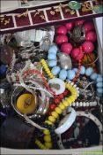 A box of vintage and retro costume jewellery to include necklaces,