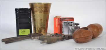 A collection of items to include a treen nut cracker, two other pairs of nut crackers,