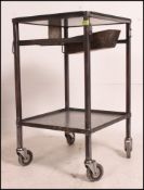 A vintage industrial 20th century polished steel logistics trolley cart having top tier with