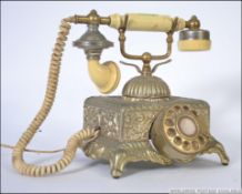 A 20th century antique style telephone cradle telephone having ring dial to centre