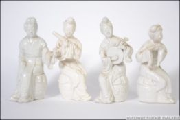 Group of 4 fine Japanese ceramic musicians , marked to base with red ink. Measures: 13cms high.