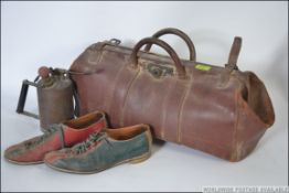 A vintage 20th leather Gladstone style bag contain a vintage brass oil dispenser and a pair of