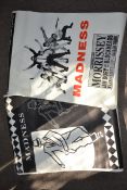 Two original music posters for the band Madness to include The Magnificent Seven Ride Again along