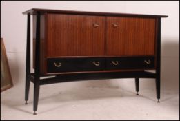 A 1970's G-Plan Librenze model sideboard having ebonised suspension set exterior frame with tola -