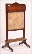 A Regency solid mahogany and fabric inset fire screen / ladies discretion screen having metamorphic
