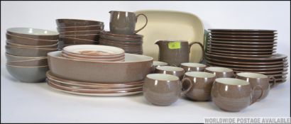 An extensive Denby dinner service in the Greystone pattern consisting of cups, saucers,