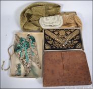A vintage mid century snakeskin ladies clutch bag together with a vintage threadwork purse,