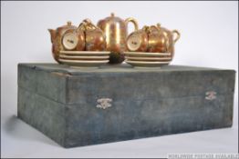 A 20th century cased Japanese Satsuma ware tea service in the original display case comprising