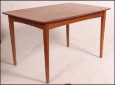 A 1960's teak drawleaf dining table, raised on tubular legs opening to reveal fold out leaf.