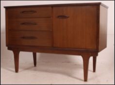 A retro teak sideboard of smaller proportions having a single door opening to reveal a shelved