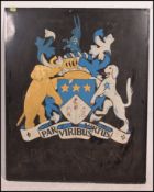 A large vintage painted metal pub sign with handpainted coat of arms design and the notation for '